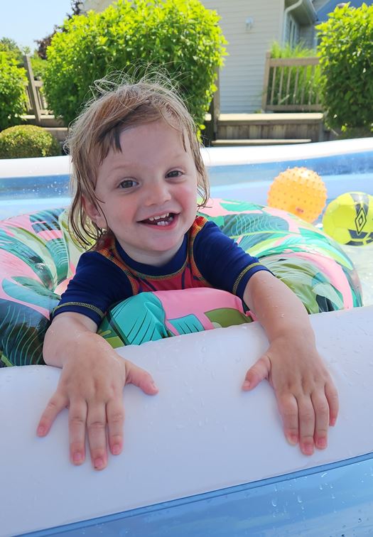 Photo Of Grayson Smiling And Happy In A Pool. Grayson Receives Services For Early Intervention.