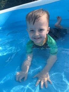 Karen smiling in a children's swimming pool. 