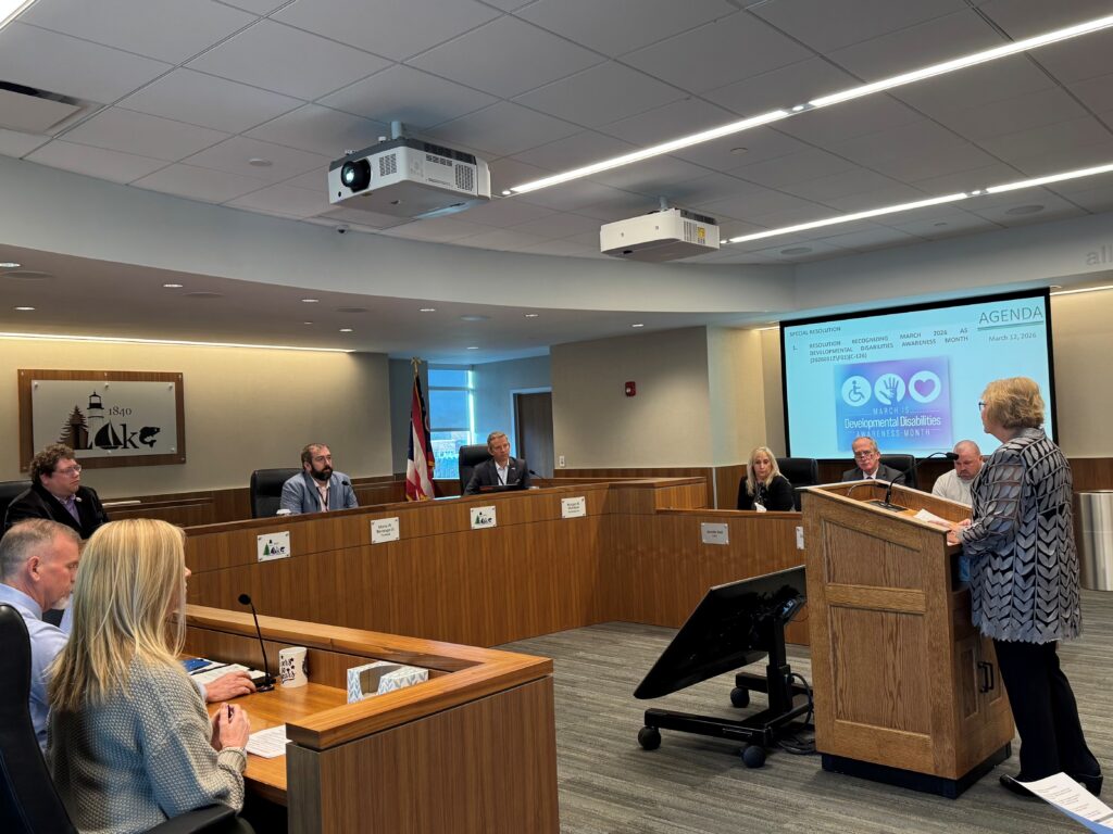 Elfie Roman presenting at the podium during the Lake County Commissioners Meeting 3-12-2026 to the local public officials for Developmental Disabilities Awareness Month.
